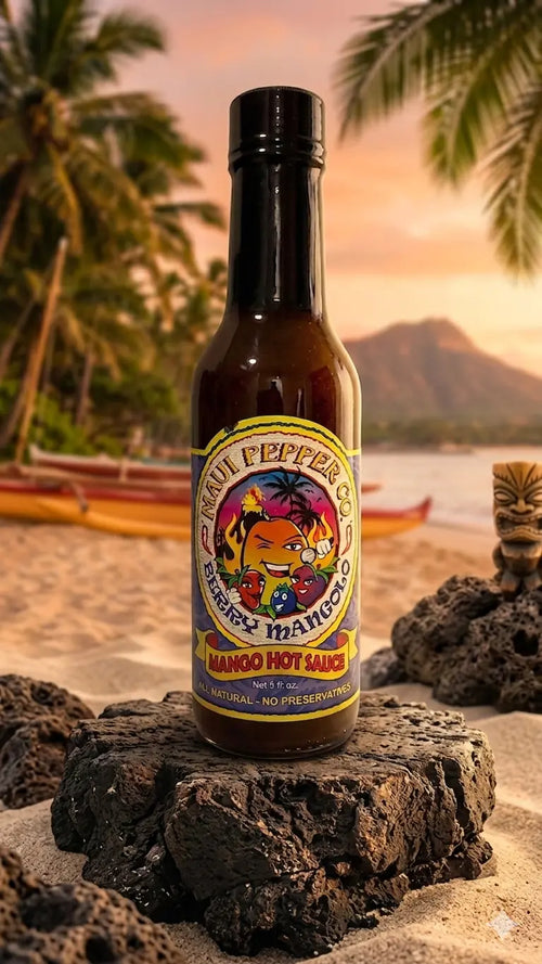 Hot sauce bottle with colorful label on a beach at sunset