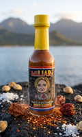 Bottle of Hillary hot sauce with a scenic background