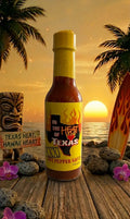 Hot pepper sauce bottle with 'In the Heat of Texas' label against a sunset beach backdrop