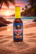 Bottle of Patriotic Hot Sauce on a beach with a sunset background