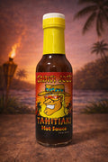 Bottle of Tahiti Joe's Tahitiaki Hot Sauce with a tropical background