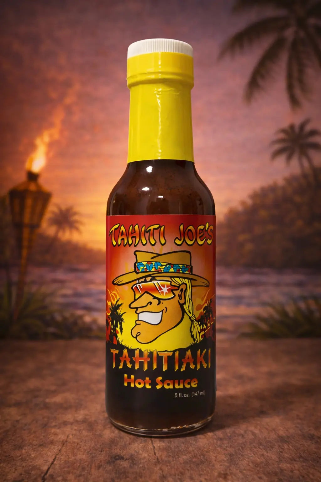 Bottle of Tahiti Joe's Tahitiaki Hot Sauce with a tropical background
